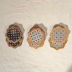 Set of six scalloped wooden coasters with blue embroidery-inspired patterns