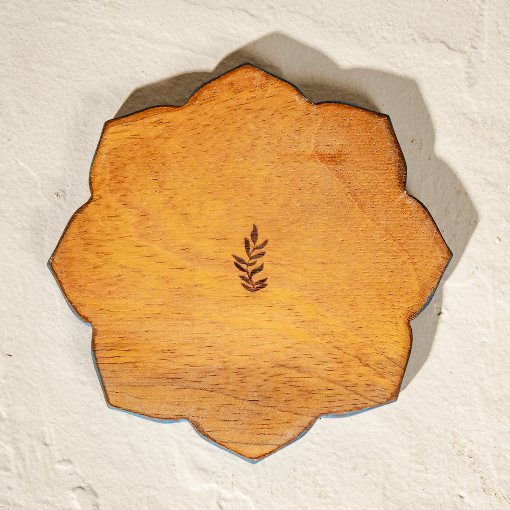 Set of six scalloped wooden coasters with blue embroidery-inspired patterns