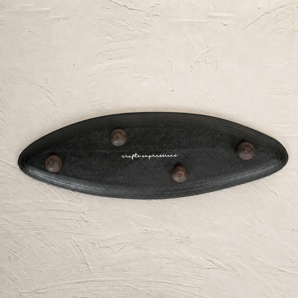 Black and white leaf-shaped wooden serving platter for snacks and mithai