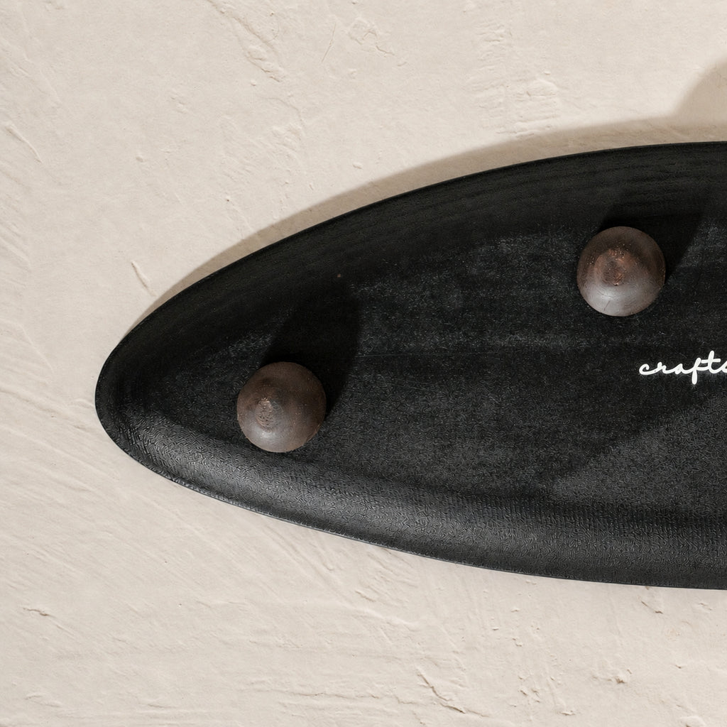 Black and white leaf-shaped wooden serving platter for snacks and mithai