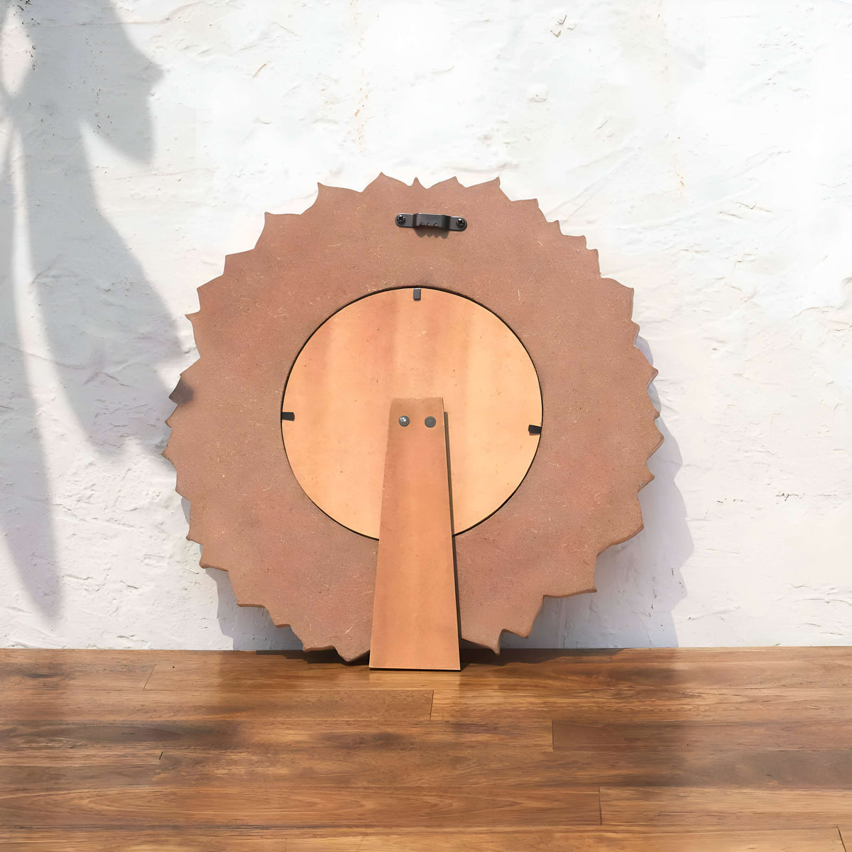 Back view of the Lotus round photo frame with easel stand and wall hook