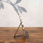 Side view of the classic white Lotus round photo frame with easel stand