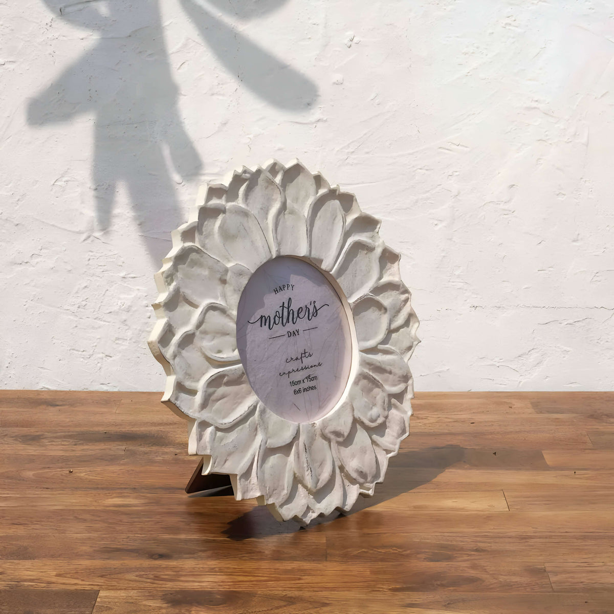Angled view of the classic white Lotus round photo frame with easel stand