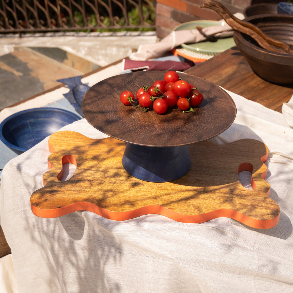 Midnight wooden cake stand styled with fruit