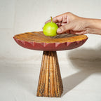 Antique gold and red wooden cake stand with flower-shaped top and tall pedestal