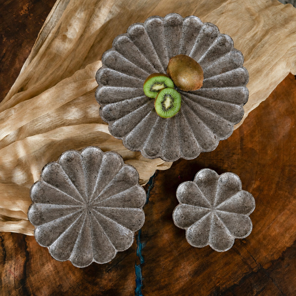 Set of three warm-silver foil flower-shaped wooden serving platters in graduated sizes