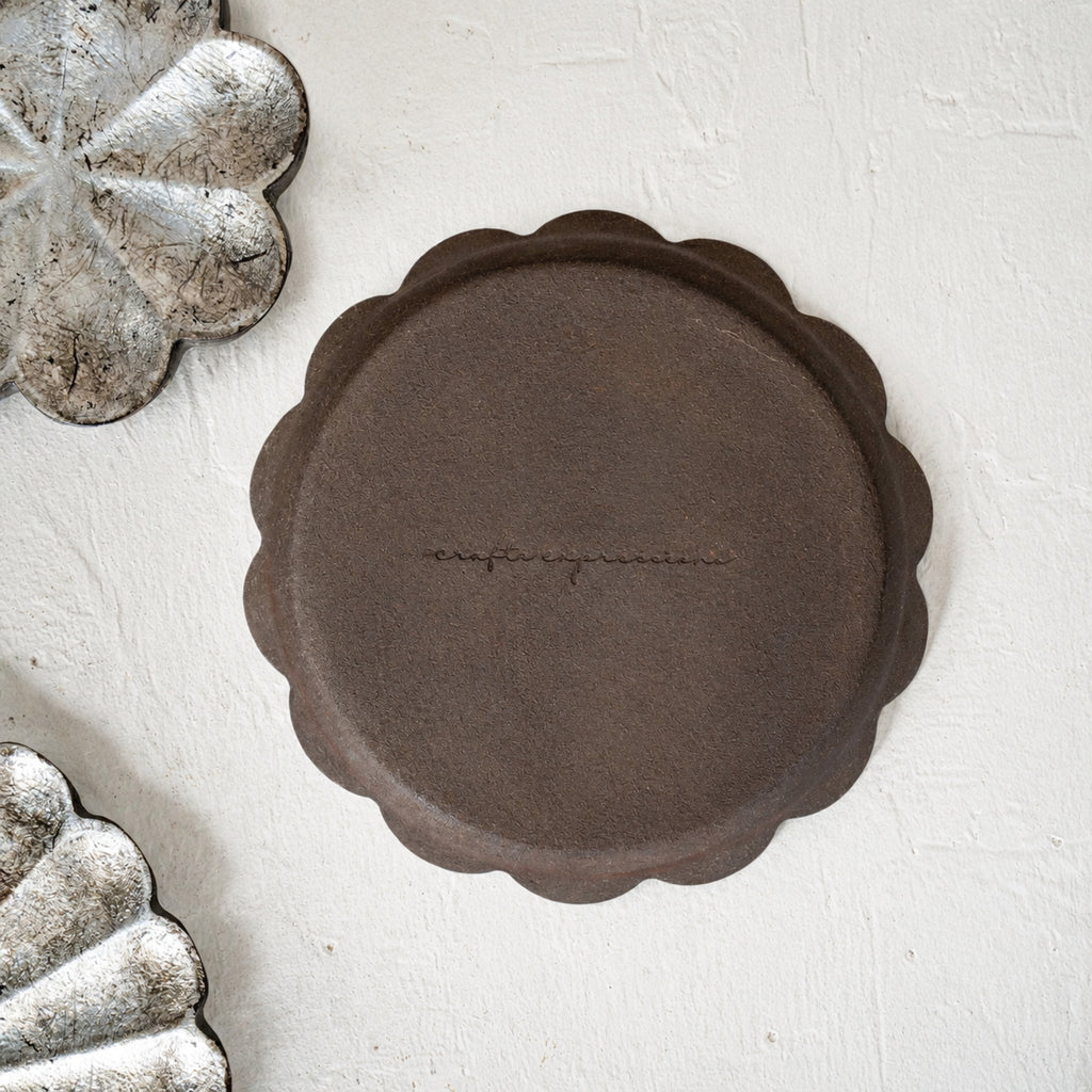 Set of three warm-silver foil flower-shaped wooden serving platters in graduated sizes