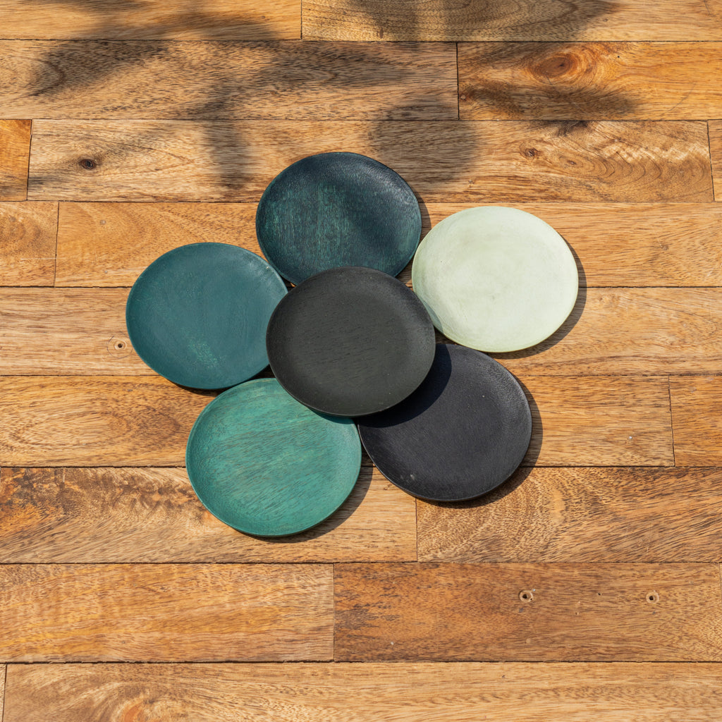Top view of Monsoon wooden coasters arranged in a flower shape