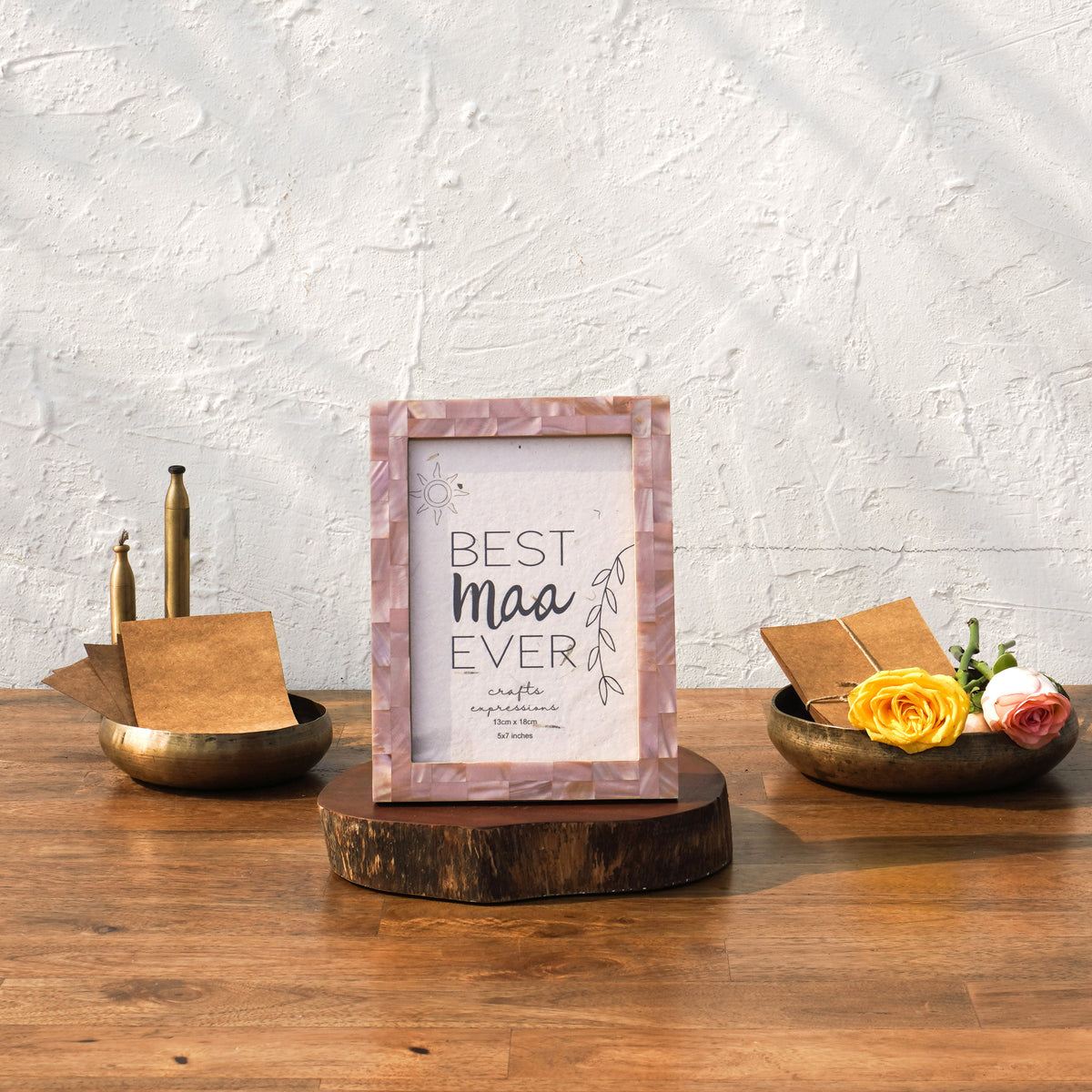 Earthy pink Mother of Pearl photo frame styled vertically on a table