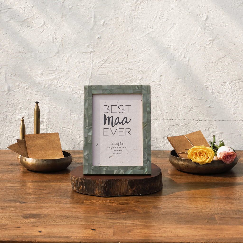 Olive-tone Mother of Pearl photo frame styled vertically on a table