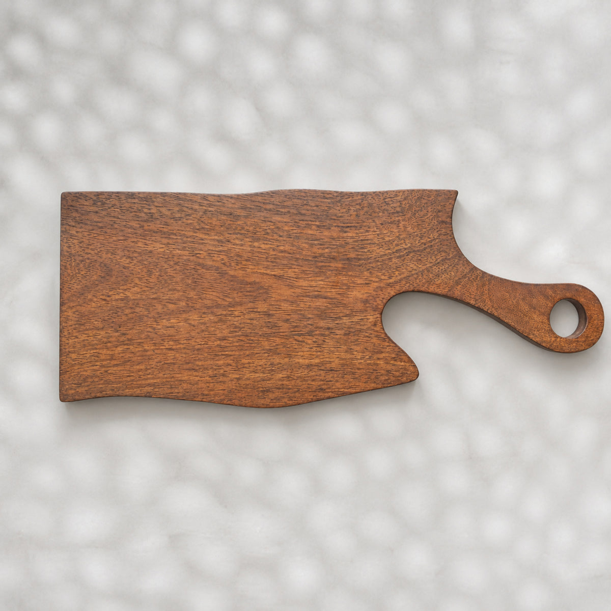 Set of two natural wooden serving boards with sculpted curved cut-outs and handles
