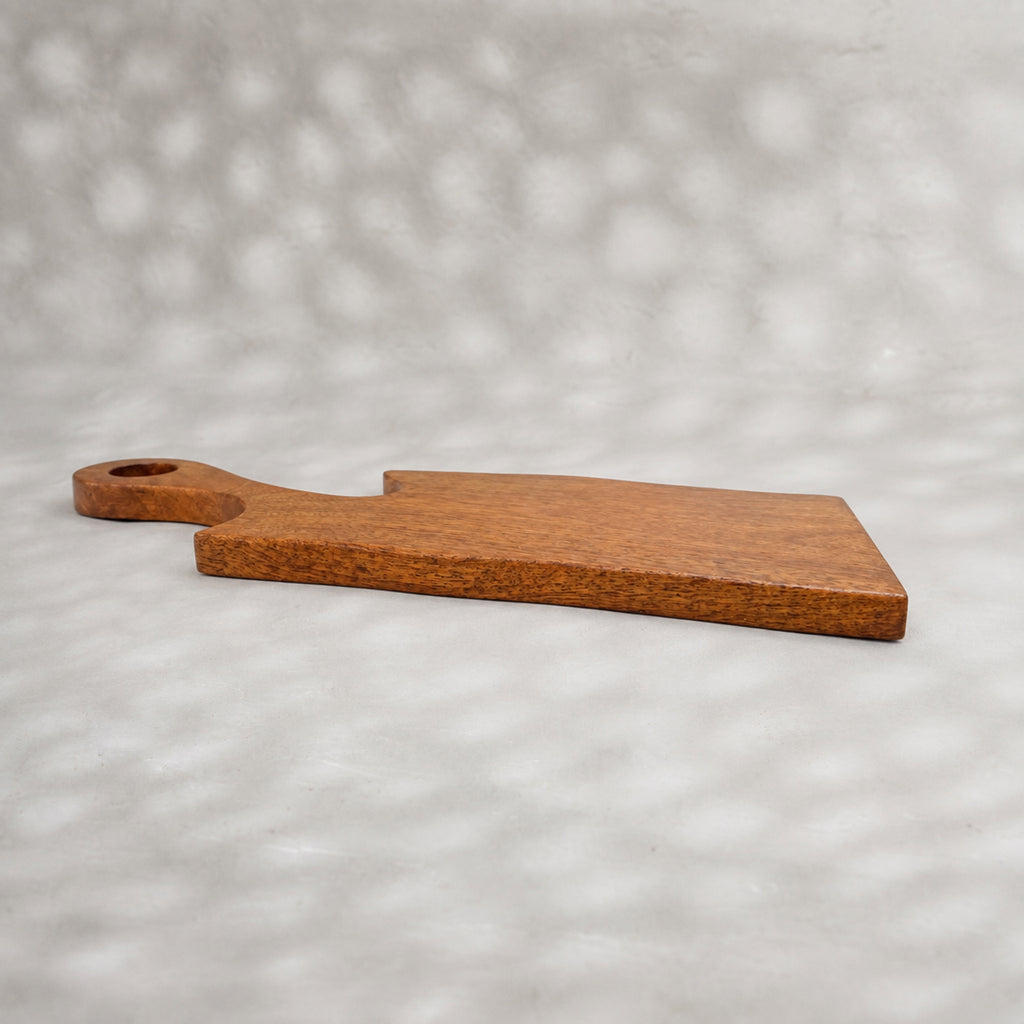 Set of two natural wooden serving boards with sculpted curved cut-outs and handles