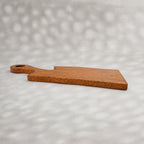 Set of two natural wooden serving boards with sculpted curved cut-outs and handles