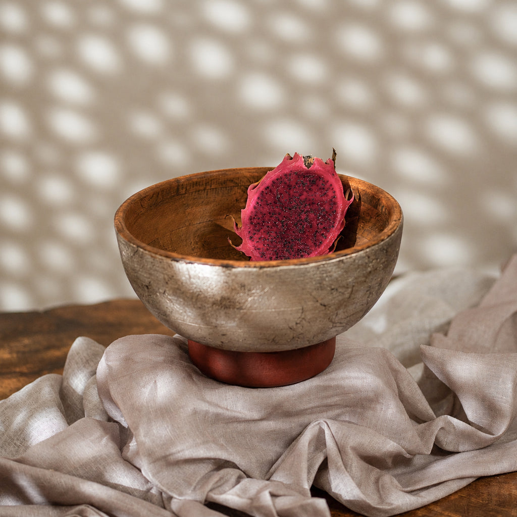 Warm silver wooden serving bowl with a red pedestal base