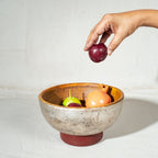 Warm silver wooden serving bowl with a red pedestal base