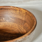 Warm silver wooden serving bowl with a red pedestal base