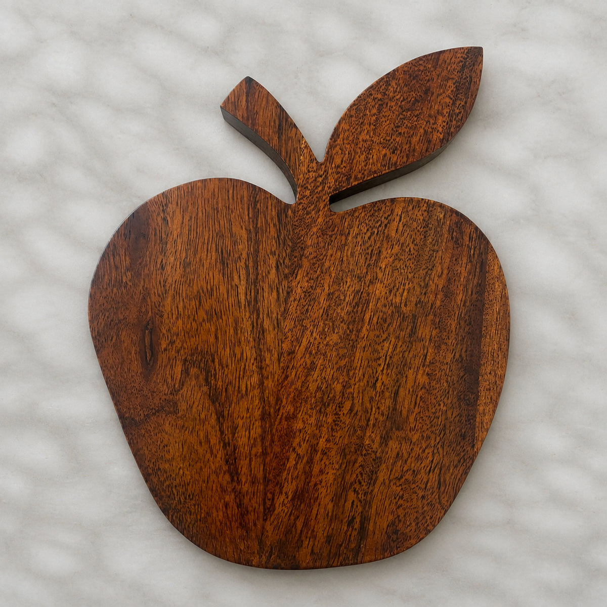 Apple-shaped natural wooden trivet with a carved leaf
