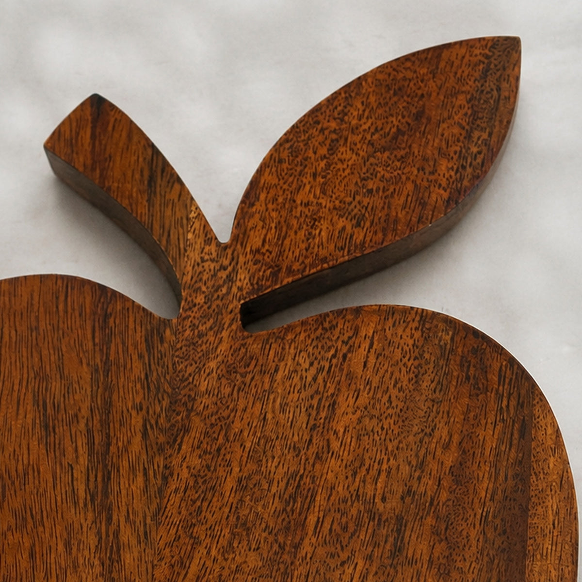 Close-up of the leaf detail on the Orchard apple-shaped wooden trivet