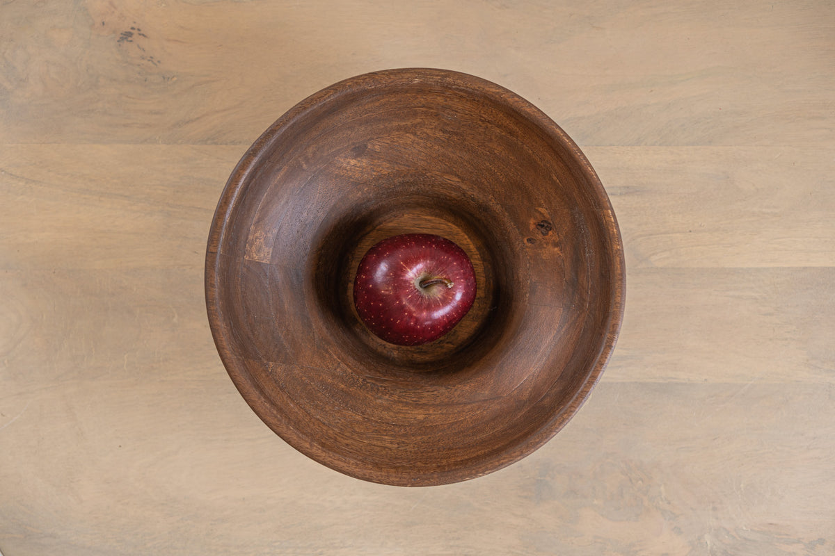 Top view of the Oro wooden serving bowl with an apple
