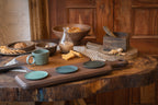 Paddle wooden cheese board styled with tableware and snacks