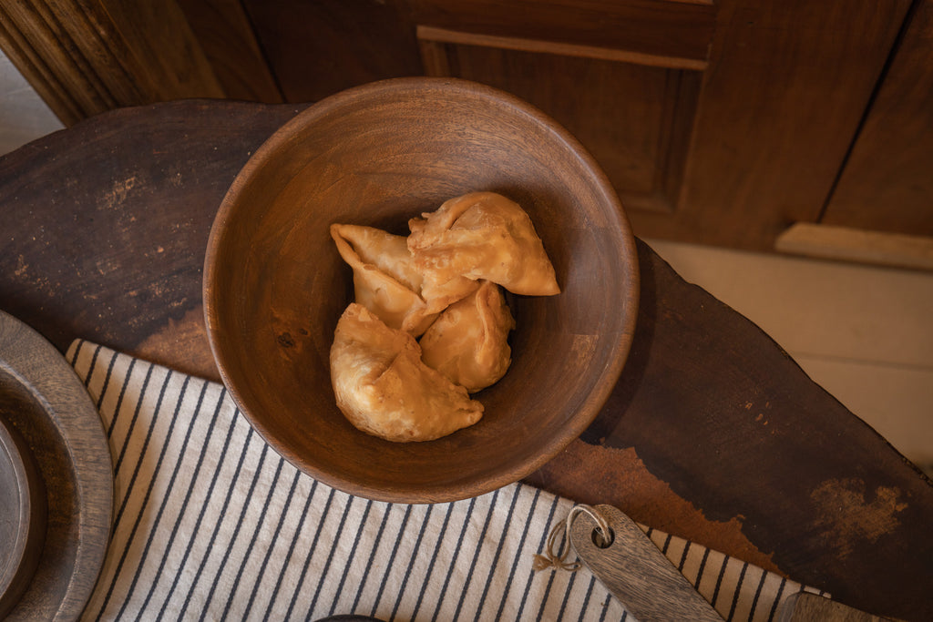 Oro wooden serving bowl styled with snacks