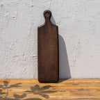 Paddle wooden cheese board standing upright