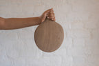Pebble Ash wooden platter held upright in one hand
