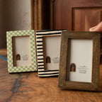 Set of three wooden Polaroid photo frames in green, striped and natural finishes