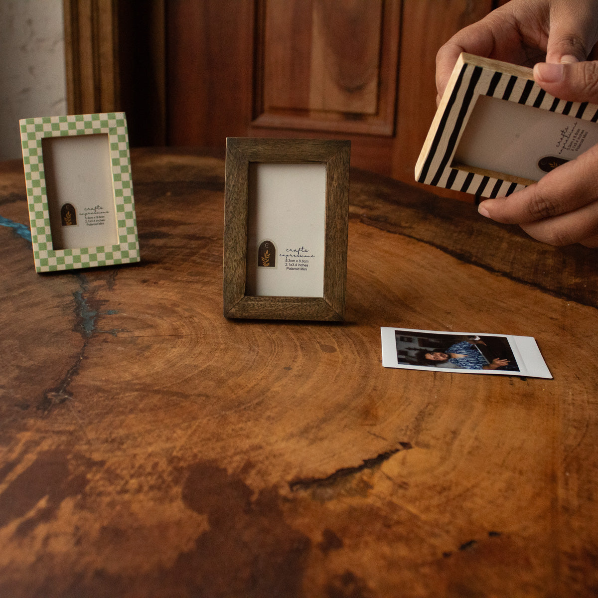 Set of three wooden Polaroid photo frames with a loose instant photo