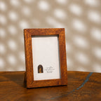 Textured earthy-brown wooden photo frame for a 4 by 6 inch photograph