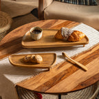 Two Spaceship wooden riser stands styled with baked goods and a cup
