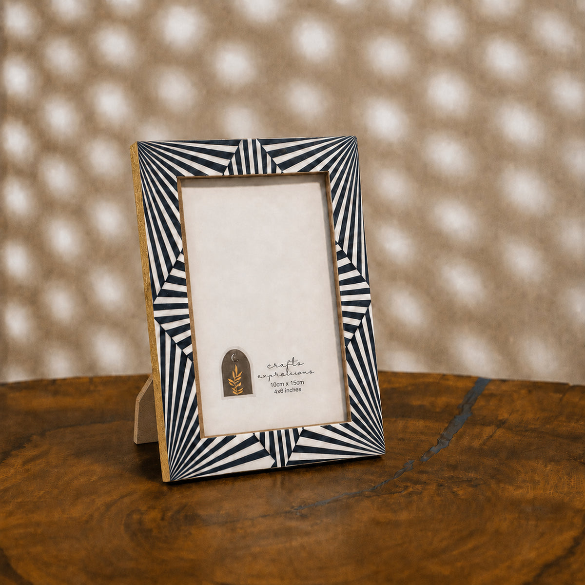Black and white starburst wooden photo frame for a 4 by 6 inch photograph