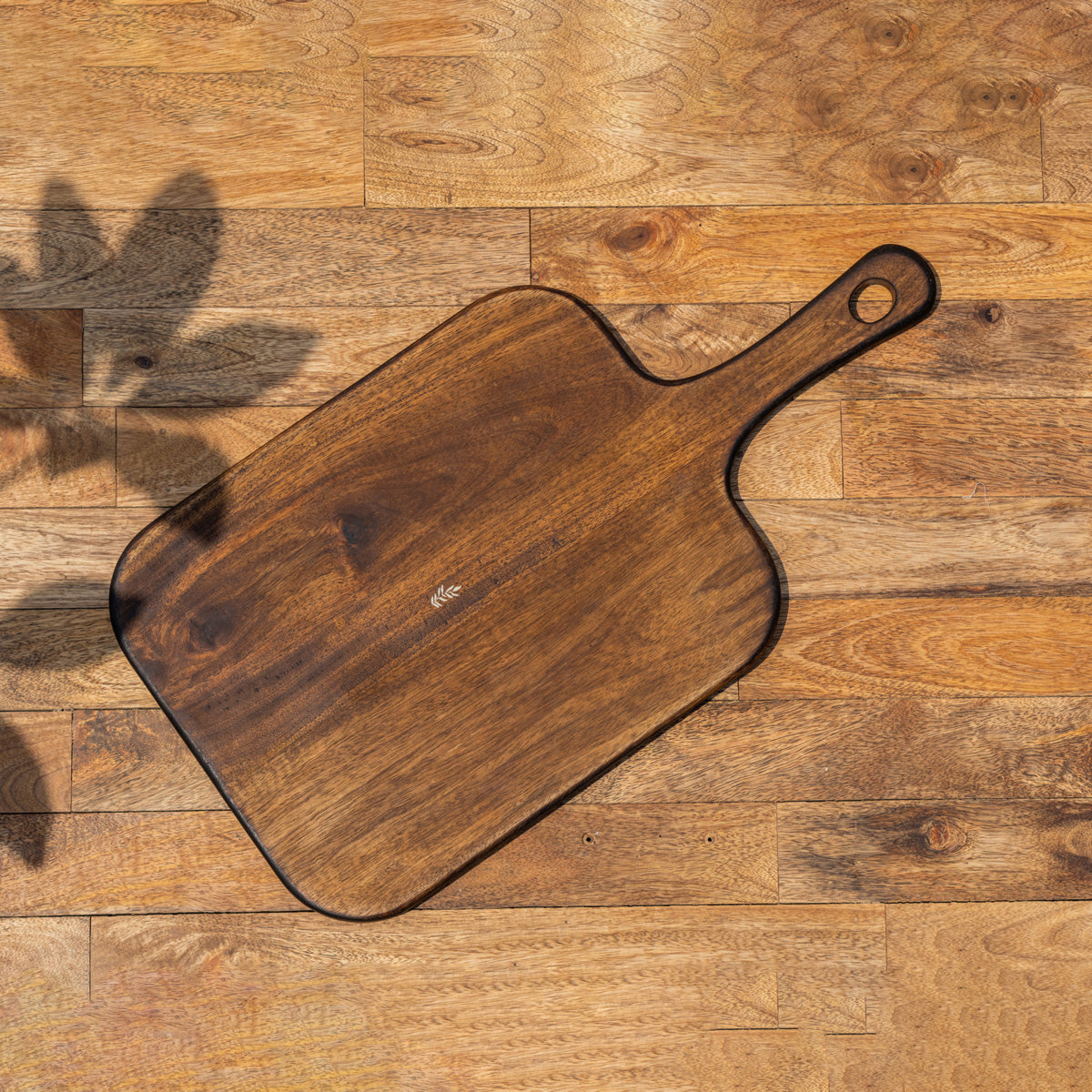 Glide natural wood chopping board with handle viewed from above