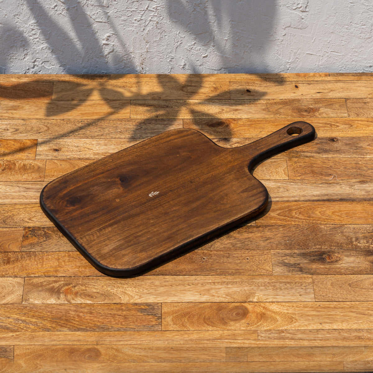 Glide wooden chopping and serving board shown at an angle