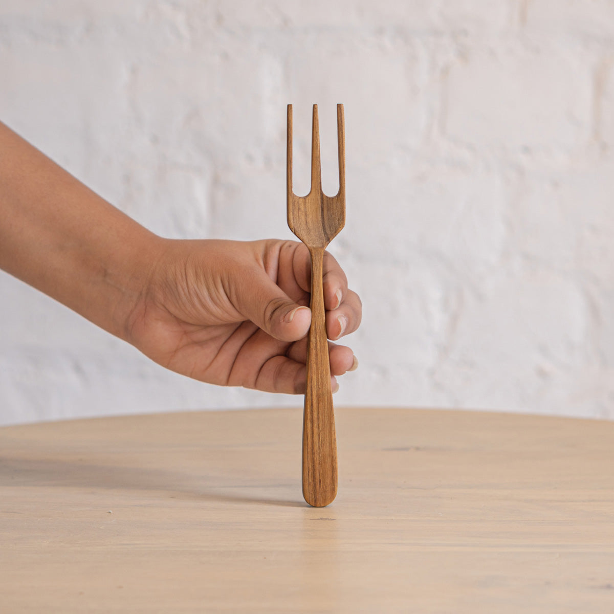 Glide wooden fork held upright in one hand