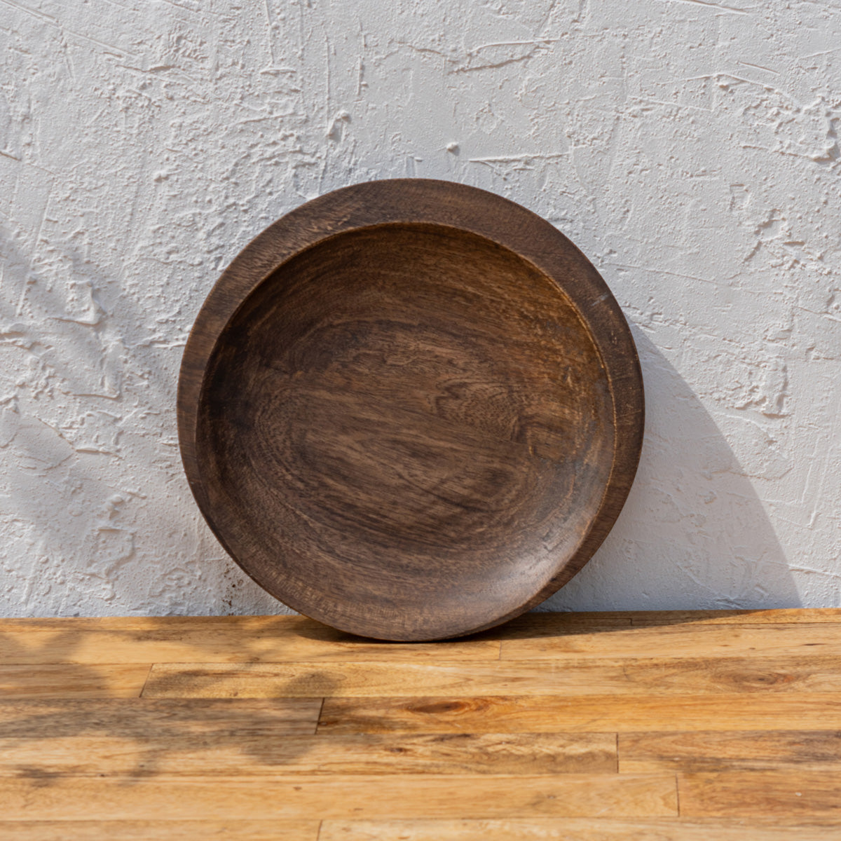 Front view of the Moon wooden platter standing upright