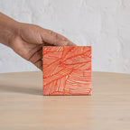 Palash printed coaster held in one hand
