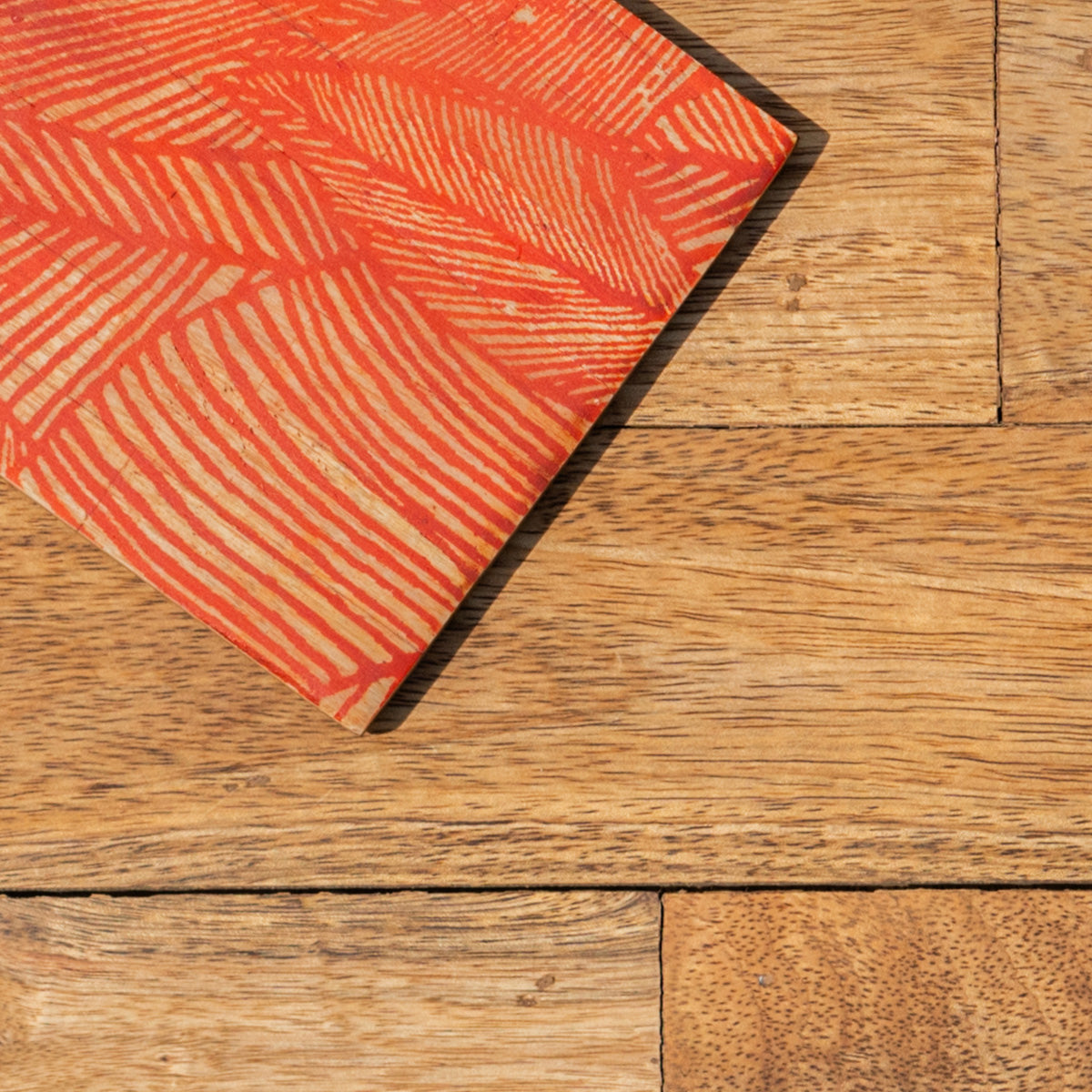Close-up of the orange pattern on a Palash printed coaster