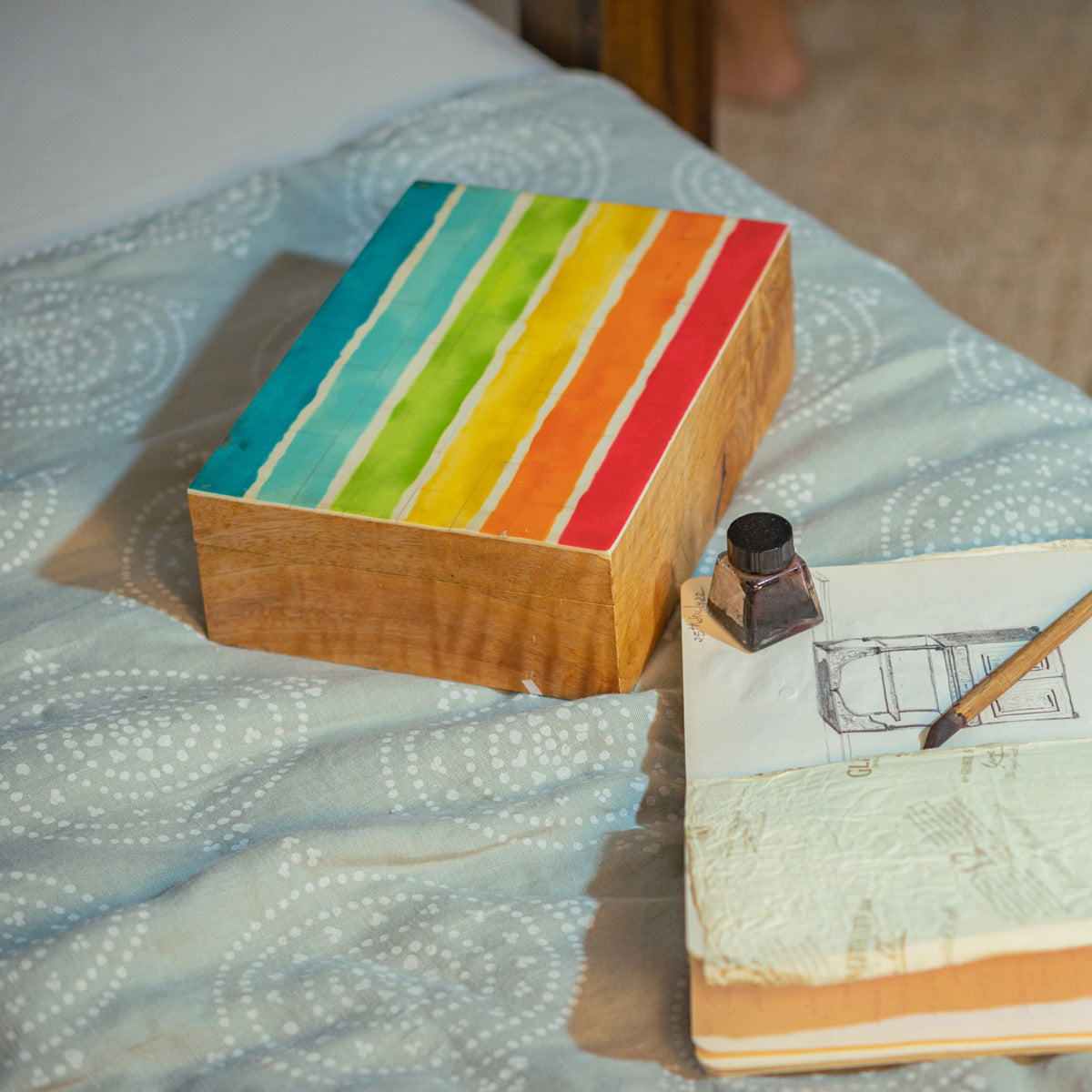 Closed Pride wooden storage box styled on fabric