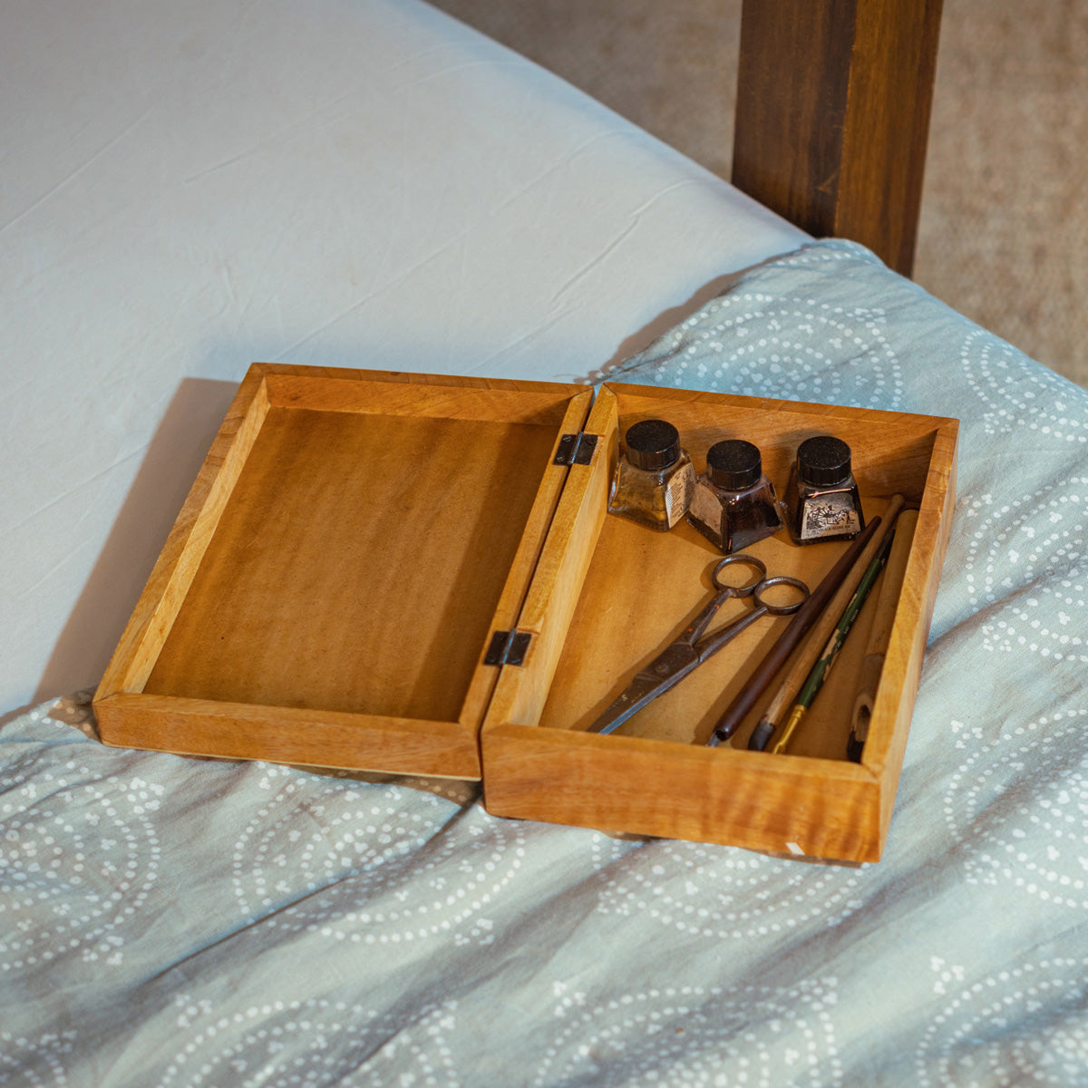 Open Pride wooden storage box styled with small bottles
