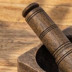 Close-up of the carved wooden pestle and mortar rim