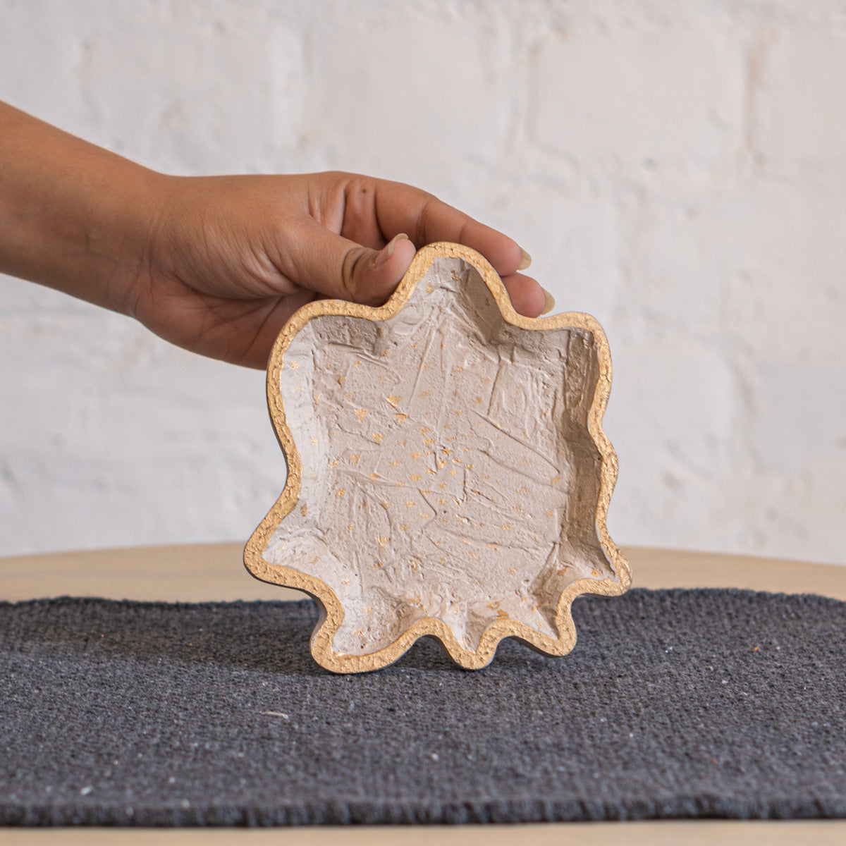 Twister trinket tray held in one hand