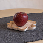 Twister trinket tray holding a red apple