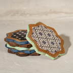Stacked Kasida wooden coasters showing varied blue patterns