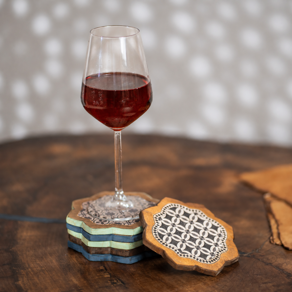 Kasida wooden coaster set styled with a wine glass