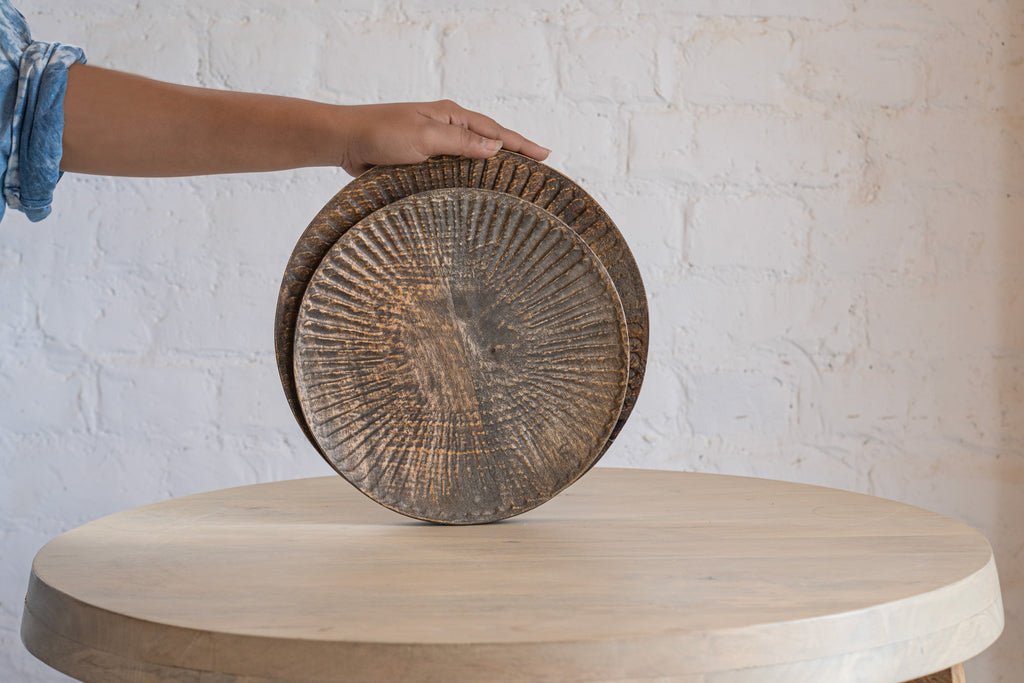 Terrain wooden platter set held upright in one hand
