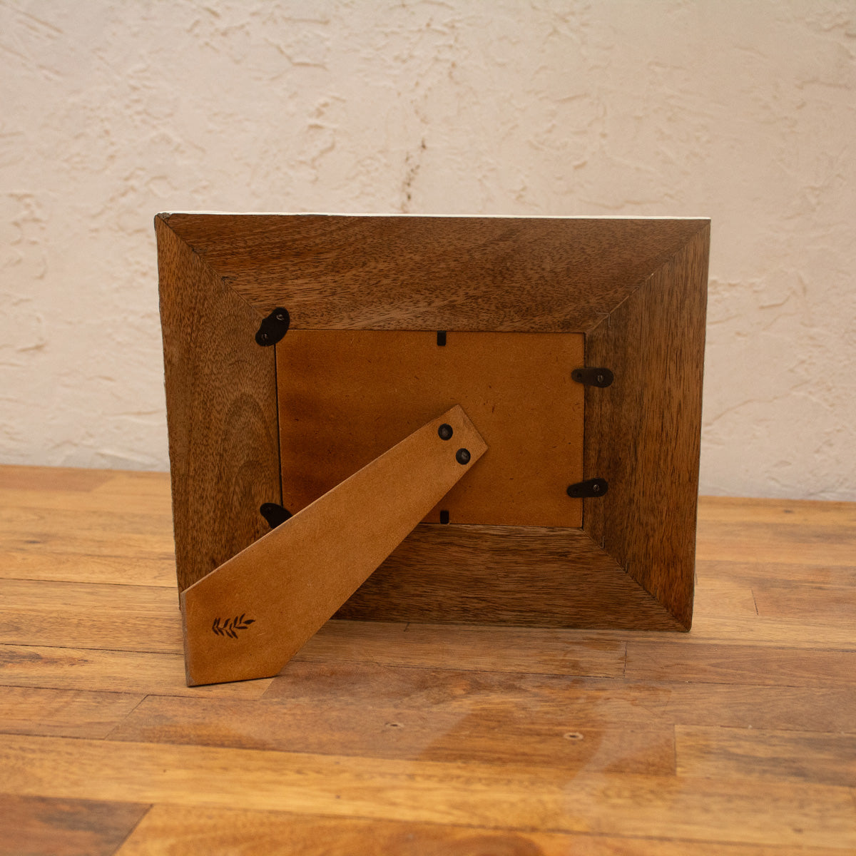 Back view of the Waves wooden photo frame displayed horizontally with easel stand