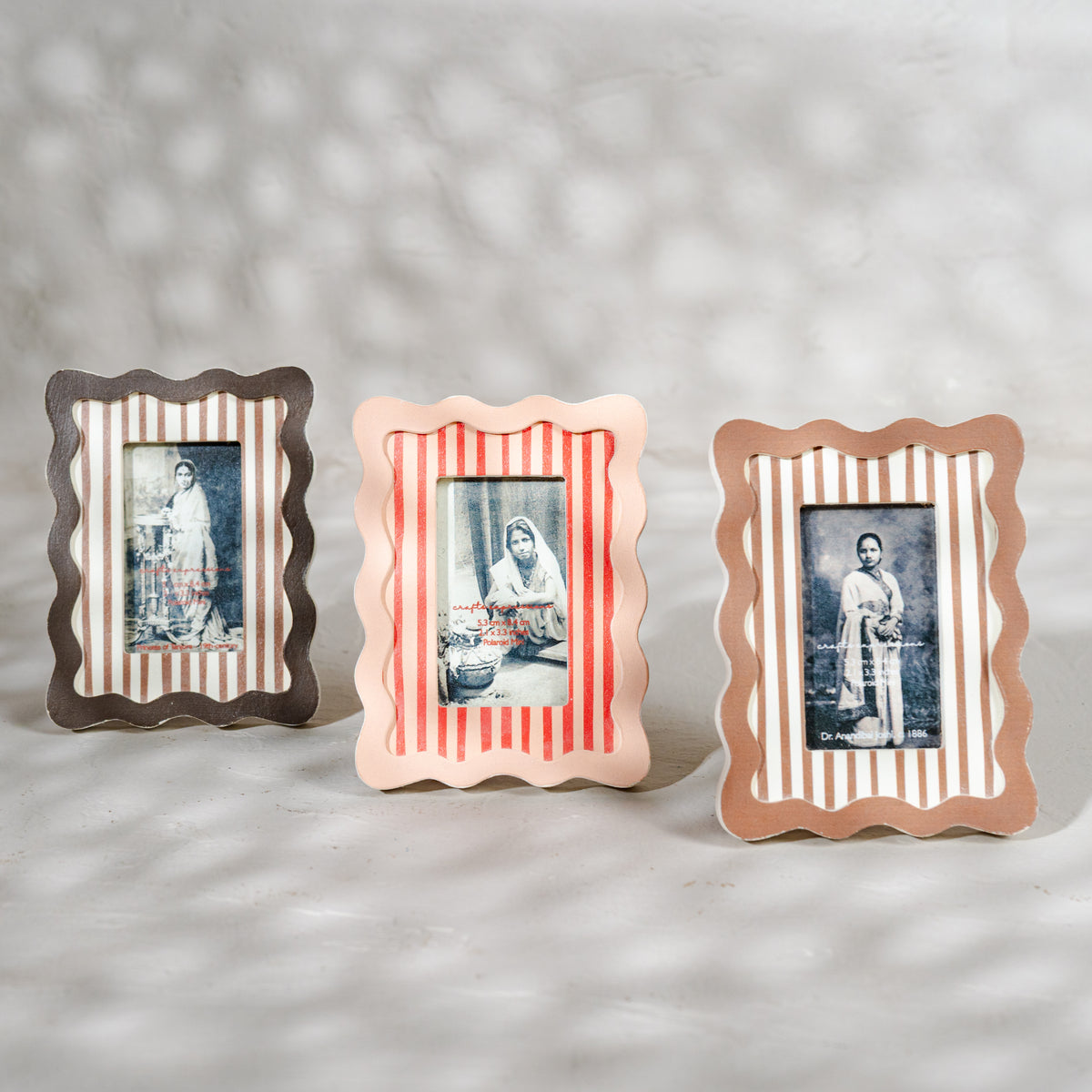 Set of three wavy wooden Instax Mini photo frames in taupe peach and warm red