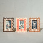 Set of three wavy wooden Instax Mini photo frames in taupe peach and warm red