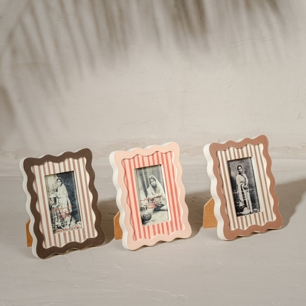 Set of three wavy wooden Instax Mini photo frames in taupe peach and warm red